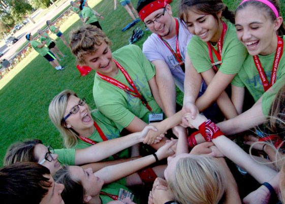 group of ambassadors holding hands