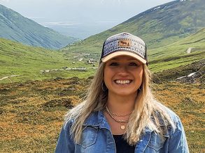 Taylor with an Alaskan mountain background